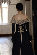 Close back view of black maxi dress with antique lace off-shoulder neckline and corset tie detail