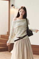 Front view of VOGSION apricot off-shoulder pointelle knit sweater with wide foldover neckline