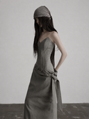 Side view of the fitted boned bodice and column skirt on the gray corset maxi dress