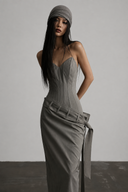 Three-quarter view of the gray drop-waist corset maxi dress and long fixed wrap tie
