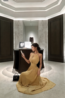 VOGSION Aureline champagne gold petite maxi dress seated with flowing skirt