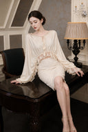 VOGSION Aveline reversible satin lace-trim blouse and sequin pencil skirt, seated view