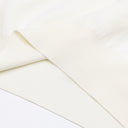 Close-up of Aveline ivory wool sweater ribbed hem