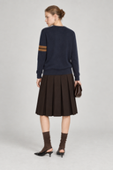 Back view of Aveline navy wool sweater with caramel stripes on the left sleeve