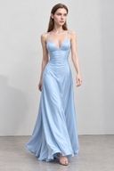 Model walking in Avelise light blue maxi dress with a flowing skirt