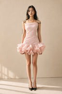 Full-length front view of the light pink petal ruffle mini dress