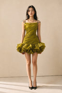 Full-length front view of the VOGSION Azalea olive green petal ruffle mini dress