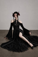 Black glitter velvet Gothic maxi dress with lace-trimmed flowing skirt, seated view