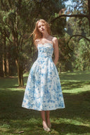 Front view of the VOGSION blue and white floral semi-formal wedding guest dress with a fitted waist and full midi skirt