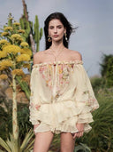 Front view of VOGSION butter yellow floral off-shoulder romper