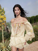 Close view of braided off-shoulder neckline and floral print on VOGSION romper
