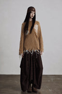 Front view of camel distressed knit sweater with fixed white open-knit panels
