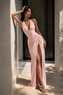 Blush pink halter chiffon maxi dress with plunge neckline, corset bodice, ruched draping and thigh-high slit for weddings, bridesmaids and formal occasions.