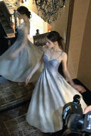 Ice blue silver glitter floor-length prom dress reflected in an ornate mirror