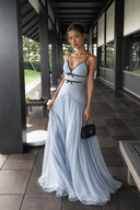 Three-quarter view of the Vogsion Célestine blue dress with black trim, bow accents, spaghetti straps, and a floor-length flowing skirt for elegant summer events