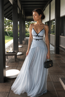 Vogsion Célestine icy blue bow-trim chiffon maxi dress front view, featuring black contrast trim, spaghetti straps, and a flowing light blue skirt for wedding guest and resort evening styling.