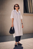 Minimalist black Cloudshell Convertible Mini Hobo Bag styled with an oversized white shirt and everyday casual outfit.