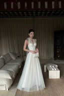 Vogsion Elara Ivory Halter Corset Tulle Gown styled in doorway, petite-friendly white formal dress with raised waistline
