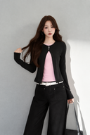 VOGSION Elina black petite top with blush pink inset and three pink neckline buttons