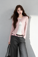 VOGSION Elina blush pink faux-layer top, close model view of fitted waist and long sleeves