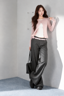 VOGSION Elina blush pink petite faux-layer top, model leaning against a sunlit wall