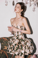 VOGSION Élodie Garden Green petite floral sequin corset bubble mini dress seated three-quarter view
