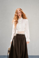 Close front view of the VOGSION Elowyn white cotton blouse, lace camisole and decorative-button skirt waistband
