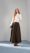 Petite woman wearing the VOGSION Elowyn white cotton blouse, lace camisole and dark brown maxi skirt set, full front view
