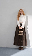 Petite model wearing the VOGSION Elowyn vintage-inspired cotton three-piece set with a dark brown maxi skirt