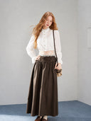 Front outfit view of the VOGSION Elowyn white ruffle blouse, lace camisole and brown petite maxi skirt