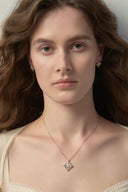 Gold tone fleur-de-lis pendant necklace with cubic zirconia center by Vogsion