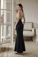 Back view of VOGSION Gilded Nocturne black and gold strapless maxi dress with zipper