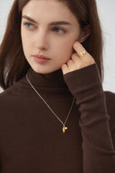     Model wearing Vogsion two-tone croissant shell statement ring with natural makeup and soft studio lighting