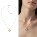 Gold tone fleur-de-lis pendant necklace with cubic zirconia center by Vogsion