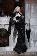 Full-length side view of black Gothic floral maxi skirt styled with matching top