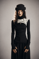 Model wearing the VOGSION Inkveil black Gothic long sleeve top with a sheer white splatter-print panel