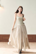 Khaki petite A-line maxi dress with a fitted waist and flowing layered skirt in motion