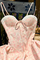     Close-up of Vogsion blush floral corset bodice showing sweetheart neckline, lace trim, front tie detail, and soft pink floral fabric