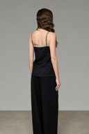 Back view of black petite-friendly layered camisole top with thin non-adjustable straps