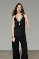 Black camisole top with fixed matcha green layered neckline and gold button details, medium front view