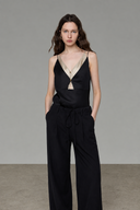 Relaxed-fit black and matcha green faux-layered camisole top in a neutral studio