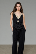 Loose-fit black contrast camisole top with matcha green faux-layer detail and wide-leg trousers