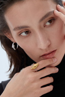    Vogsion Le Brunch Croissant Shell Adjustable Ring styled with matching necklace on model wearing brown knit turtleneck