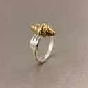  Vogsion gold and silver croissant shell open ring styled on hand with jewelry box background