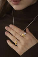     Close-up of Vogsion Le Brunch croissant shell adjustable ring with gold sculptural detail and silver-tone band