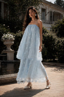 Vogsion Light Blue Fairycore 3D Floral Appliqué Tulle Fairy Princess Dress in a full-body garden portrait, dreamy light blue floral tulle maxi dress with layered silhouette, fairy aesthetic, romantic wedding guest dress, cottagecore inspired princess gown.