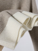 Close-up of Liorine wool sweater ivory ribbed cuffs and soft textured oatmeal yarn