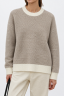 Front close-up of Liorine wool sweater showing fine textured knit and ivory ribbed neckline, cuffs and hem