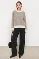 Liorine oatmeal and ivory wool sweater with contrast rib trim, styled with black wide-leg jeans, front view