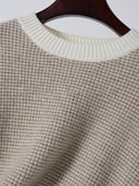 Liorine wool sweater product detail showing ivory ribbed crew neckline and fine oatmeal knit stitches